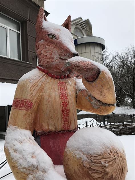 sly ukrainian fox  slavic folk costume wears  nose  snow  sits   trendy area