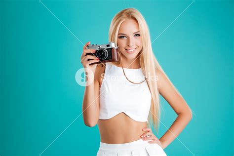 Portrait Of A Beautiful Blonde Woman Holding Photo Camera And Looking