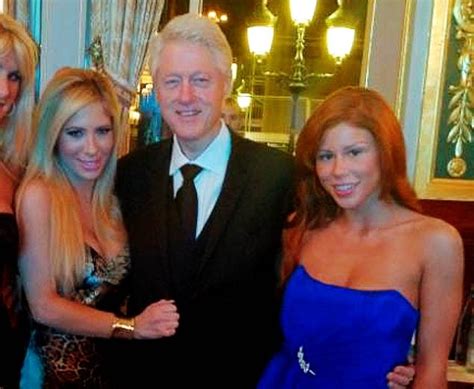 former us president bill clinton poses with two porn stars