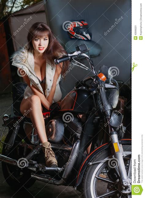 beautiful girl is sitting on a motorcycle stock image