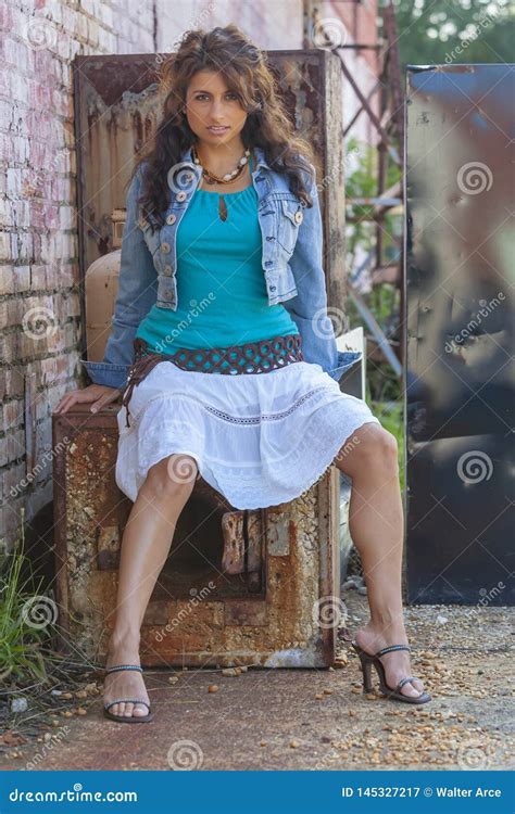 A Lovely Brunette Model Posing Outdoors With The Latest Fashions Stock