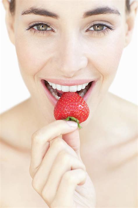 Woman Eating A Strawberry Photograph By Ian Hooton Science Photo