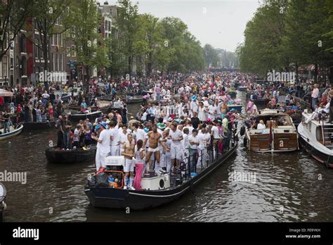 crowd on boats for gay pride canal parade in prinsengracht amsterdam