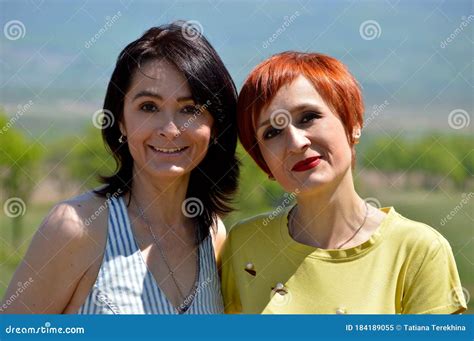 Portrait Of Two Happy Russian Sisters Sincerely Smiling On A Summer