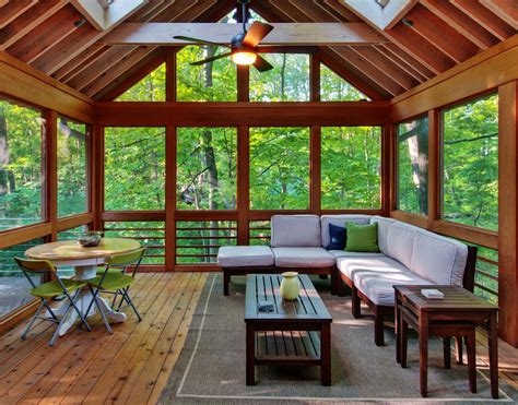 great wooden material  sun room desaign  natural view  pleasant sofa facing large glass