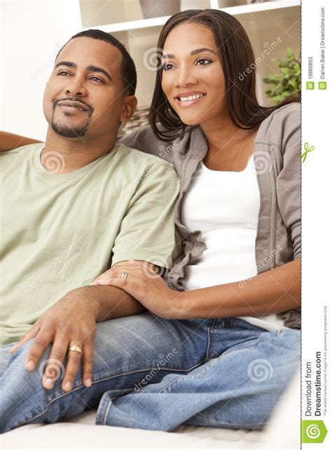Happy African American Couple Sitting At Home Stock Image