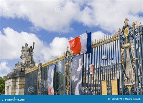 gateway   palace  versailles flags   main entrance  blue sky editorial photo