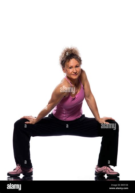 Beautiful Mature Woman On Isolated White Background Doing Stretching