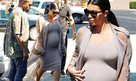 kim kardashian puts pregnant belly on display in nude dress with kanye