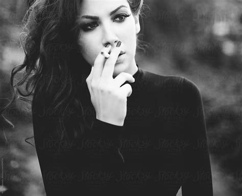 beautiful girl smoking in black and white by koki jovanovic stocksy