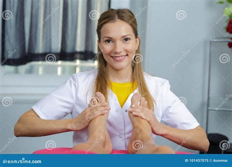 happy spa worker giving foot massage  salon stock image image