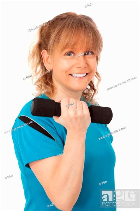 Cute Mature Woman In Gym Clothes With A Big Smile Standing Against A