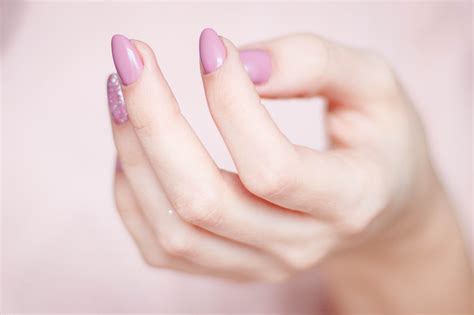 persons hand  pink manicure  stock photo