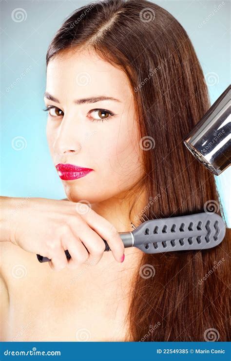 Woman With Long Hair Holding Blow Dryer And Comb Royalty Free Stock