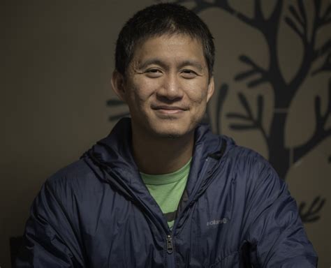 chinese guy wearing blue windbreaker jacket image  stock photo