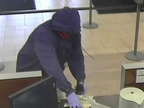 Photo Robber Fires Twice Inside Bank Flees With Cash