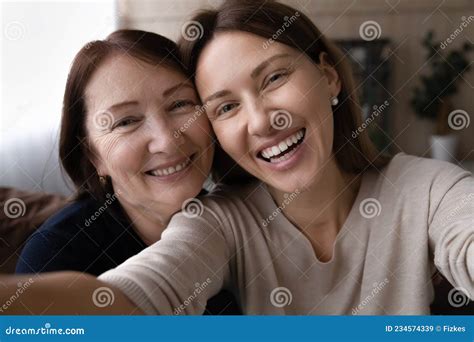 Head Shot Portrait Happy Woman With Mature Mother Taking Selfie Stock