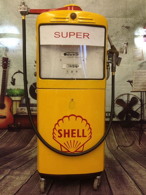 shell gas pump sitting  top   wooden floor