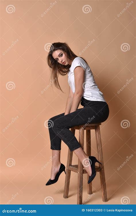 Girl Brunette Sits On A High Bar Stool Stock Image Image Of