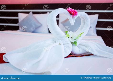 couple swans   white towel   bed   hotel room  stock