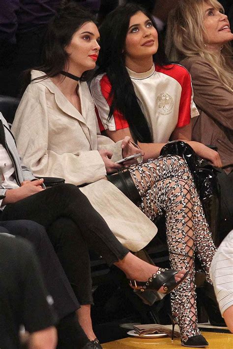 kendall and kylie jenner wear thigh high boots to lakers game