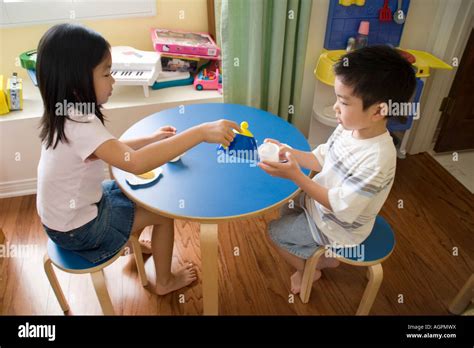 children playing  table stock photo alamy
