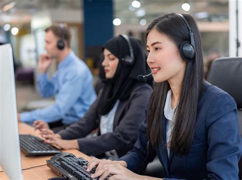 happy smiling operator asian woman customer service agent  headsets working  computer