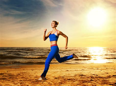 beautiful young woman running   beach  sunset beautiful young woman running   beach