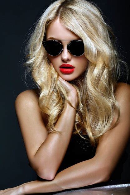 portrait of beautiful cute blonde woman girl in sunglasses with red