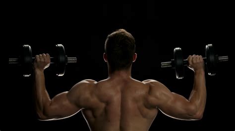 muscular man lifting dumbbells young man stock footage sbv