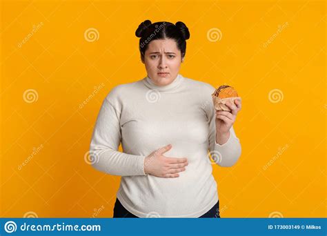Stomachache Girl Holding Burger And Touching Stomach Feeling Bad After