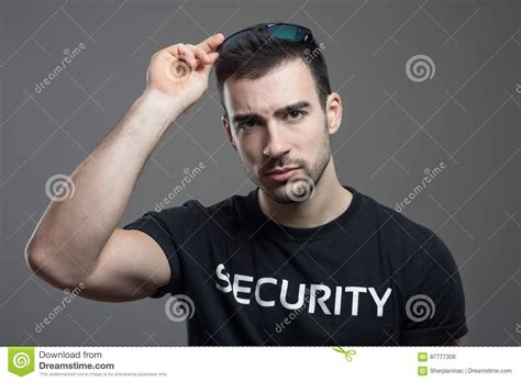 Tough Security Man Taking Off Sunglasses With Intense