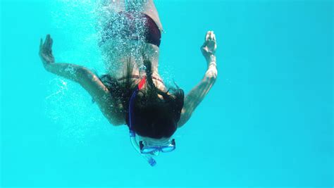 brunette swimming underwater wearing snorkel stock footage