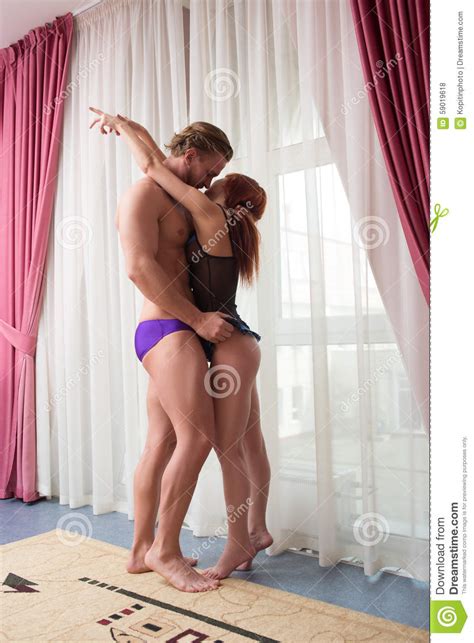 Man And A Woman In Lingerie In A Bedroom Standing Stock