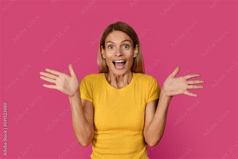 glad happy shocked middle aged european blonde lady with open mouth