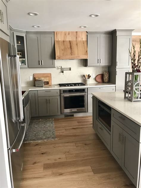 grey shaker kitchen cabinets  quartz countertops  backsplash custom wood hood modern