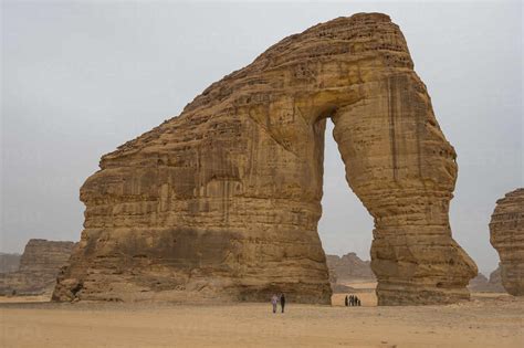 locals standing   giant arch  elephant rock al ula saudi