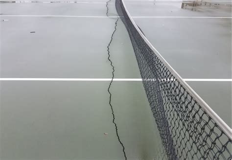 tennis court developing cracks   net varsity courts