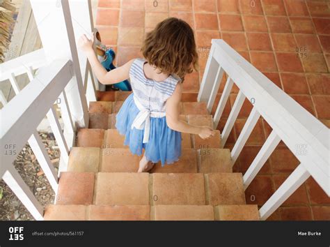girl walking  stairs leading  patio stock photo offset