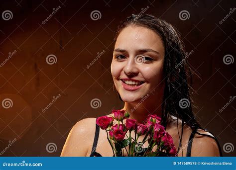 Portrait Of Young Pretty Brunette Woman In Bath With Water And Flowers