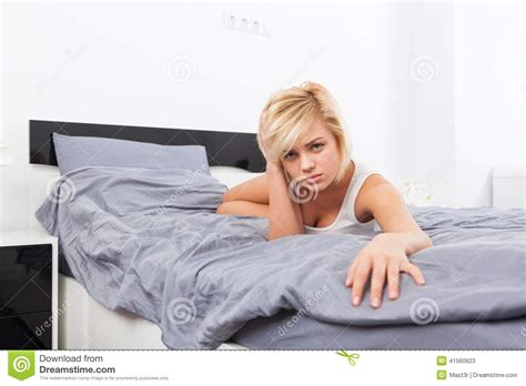 Upset Woman Covering Her Face Hand Lying On Bed Stock