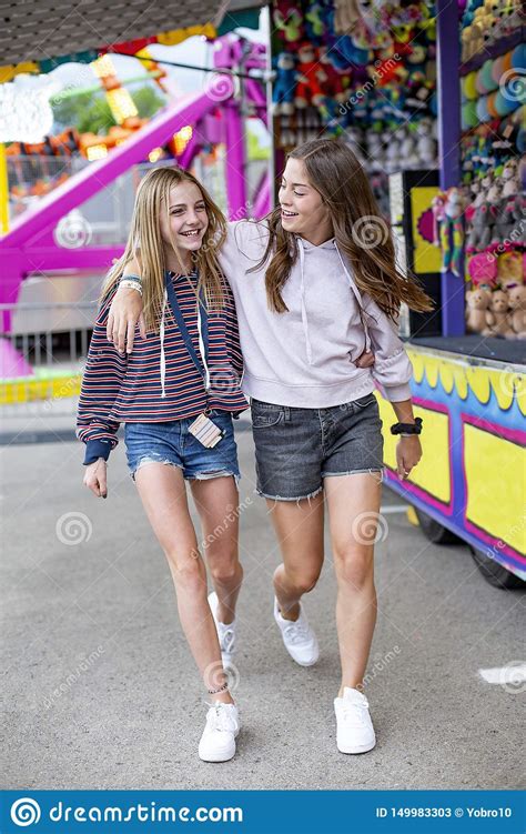 Smiling Teenagers Having Fun At An Outdoor Summer Carnival