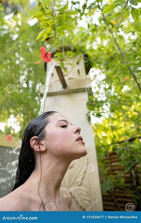 A Young Girl Is Taking A Shower Outdoors Stock Image Image Of