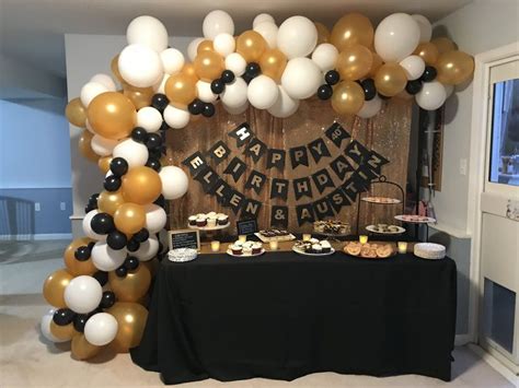 40th birthday party gold and black dessert table set up birthday