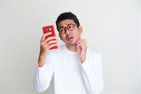 Adult Asian Man Checking His Mobile Phone After Wake Up In The Morning