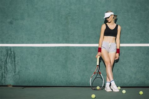 Beautiful Woman Posing On A Tennis Court Photo Free Download