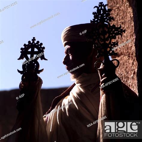 religious man holding cross stock photo picture  rights managed
