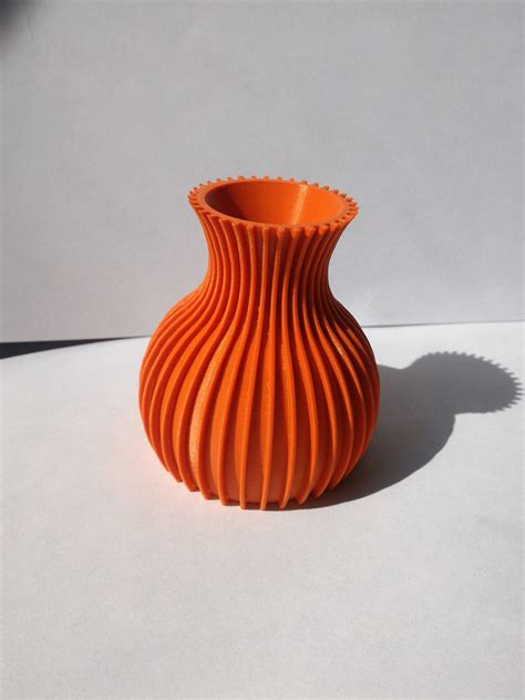 orange vase sitting  top   white table    shadow