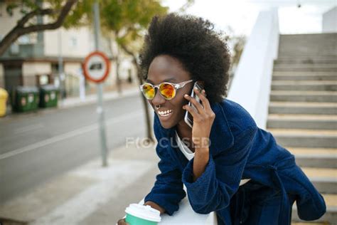 Portrait Of Young Woman Wearing Mirrored Sunglasses Talking On Mobile