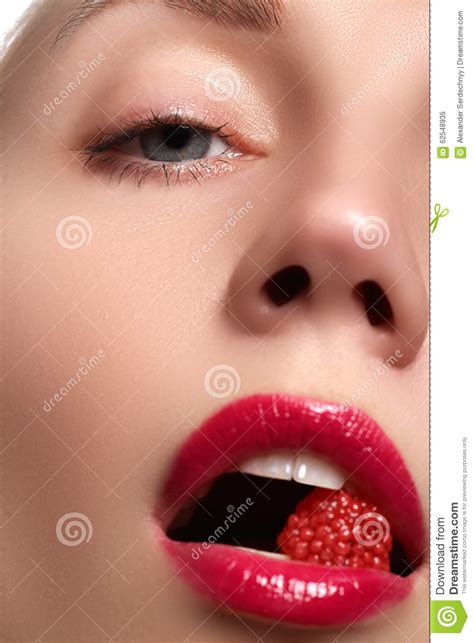 close up of woman s lips with bright fashion red glossy